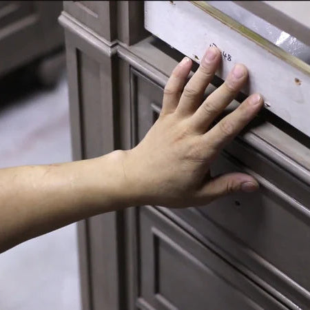 Person opening a bathroom cabinet door with a hand to check the quality
