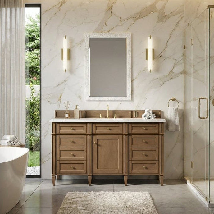 Modern bathroom with marble walls, wooden free standing bathroom vanity, and freestanding bathtub.