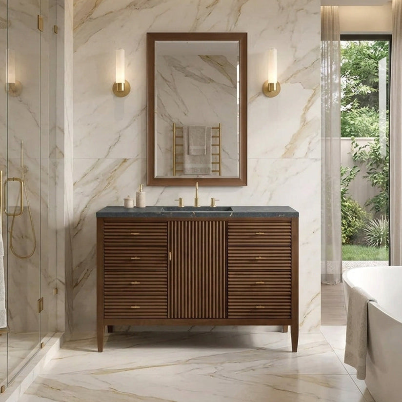Modern bathroom with marble walls, wooden vanity, and a bathtub.