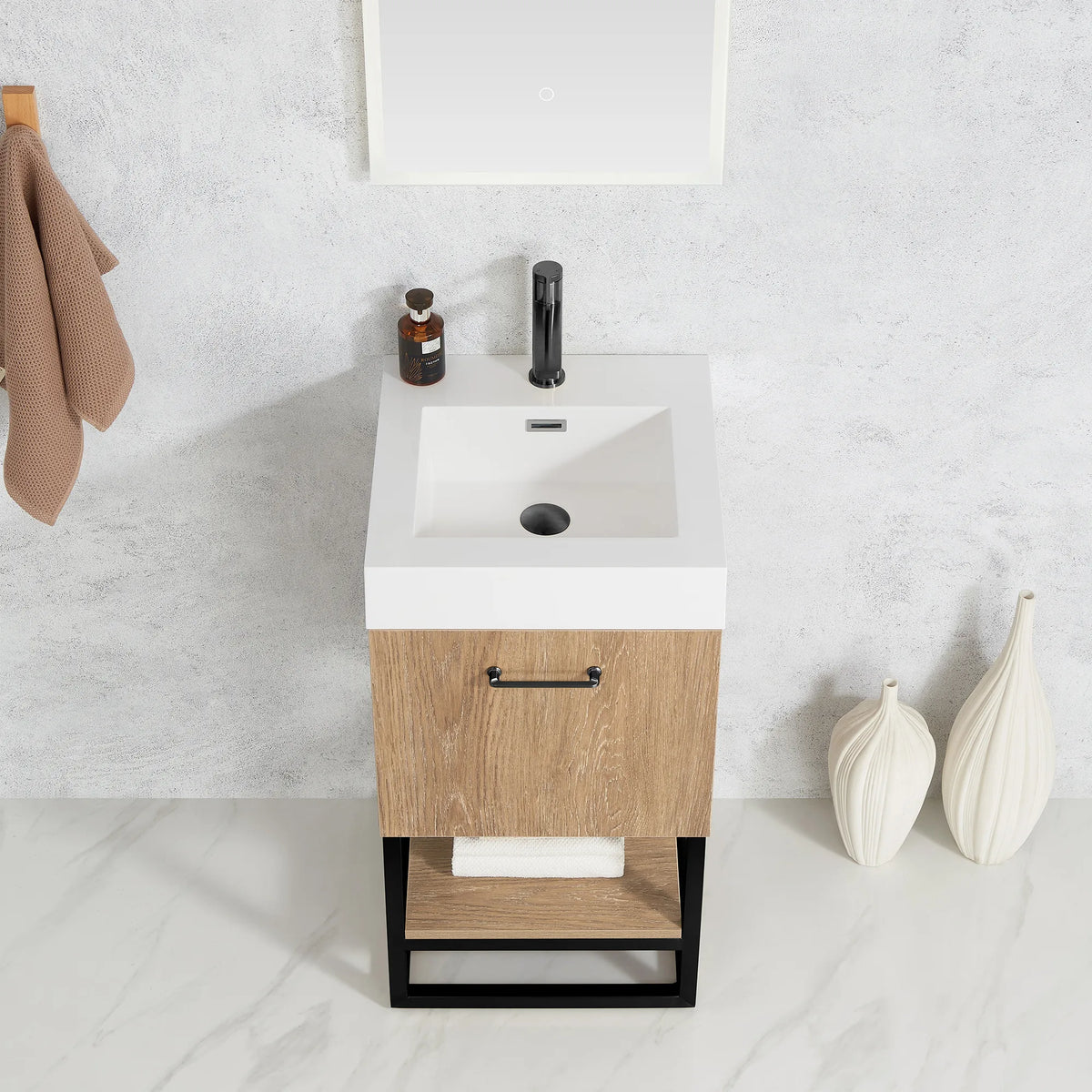 Angled close view of the white top, oak front, black pull and cream vases
