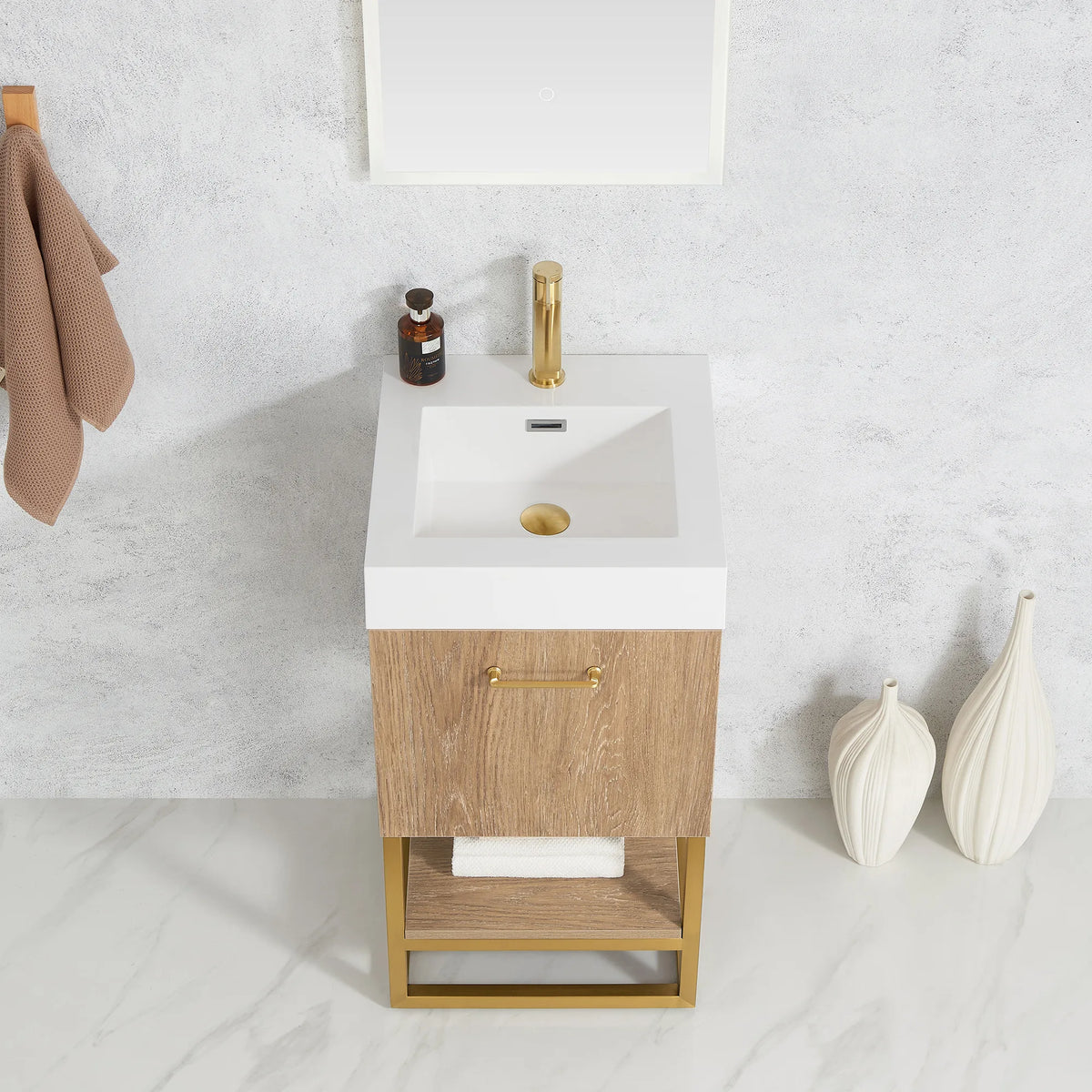 Close view of the white top with a towel on the open shelf, cream vase at the side