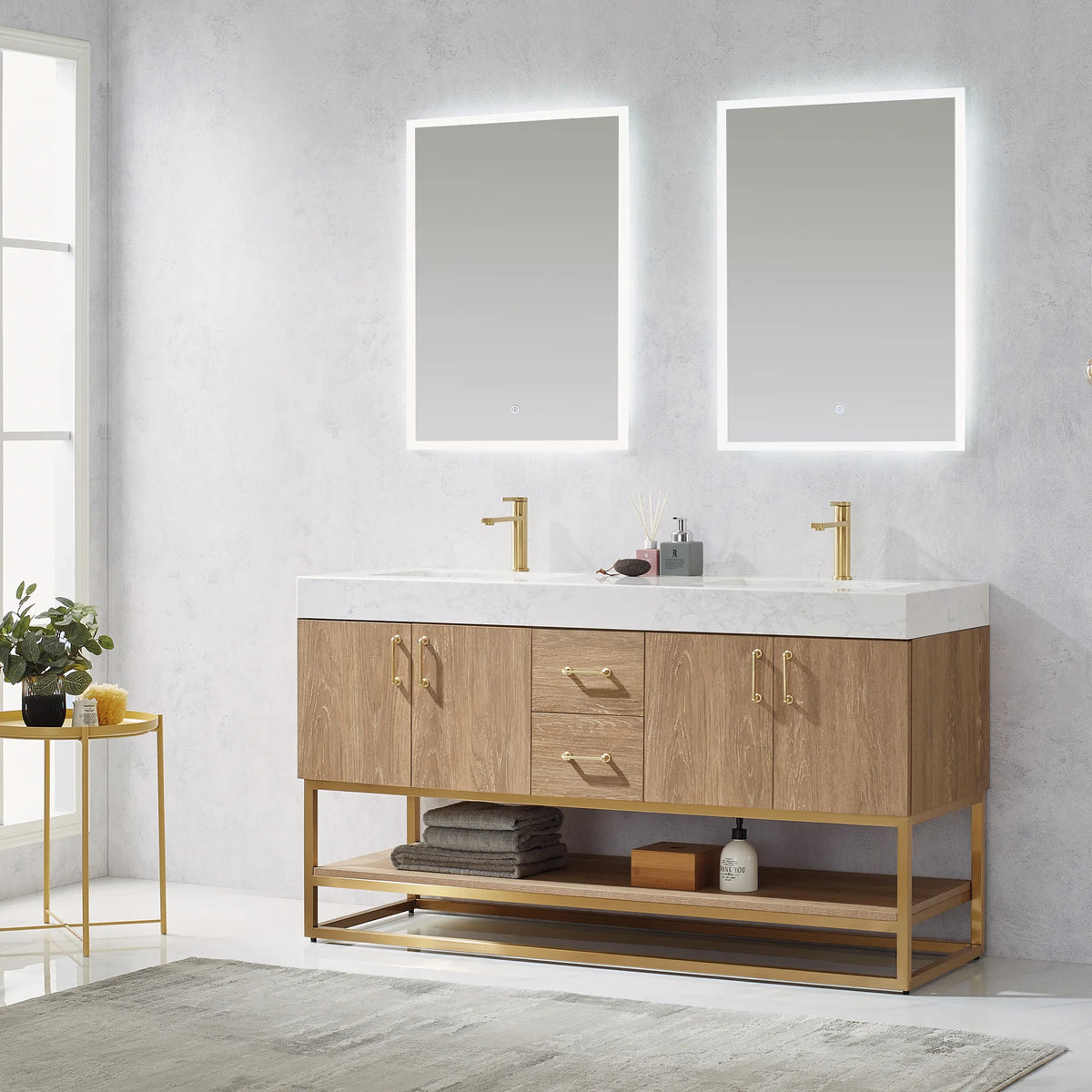 Front-facing room shot of the double vanity beneath two backlit mirrors with towels on the open shelf