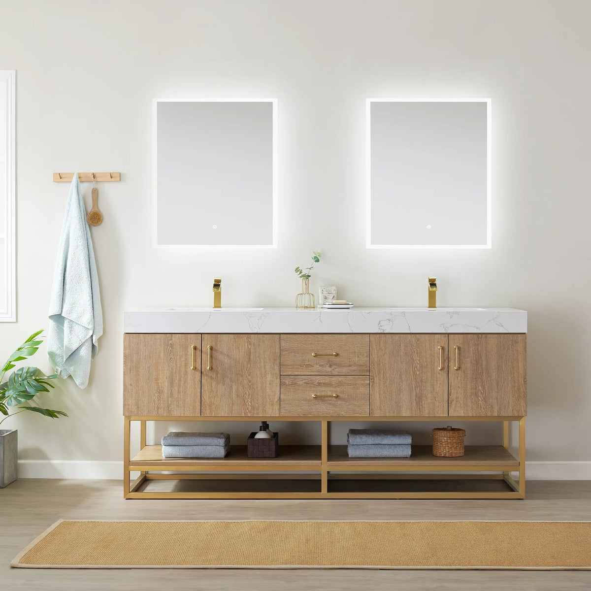 Straight-on room view of the double vanity under two backlit mirrors, with rug, wall hooks and decor on the shelf
