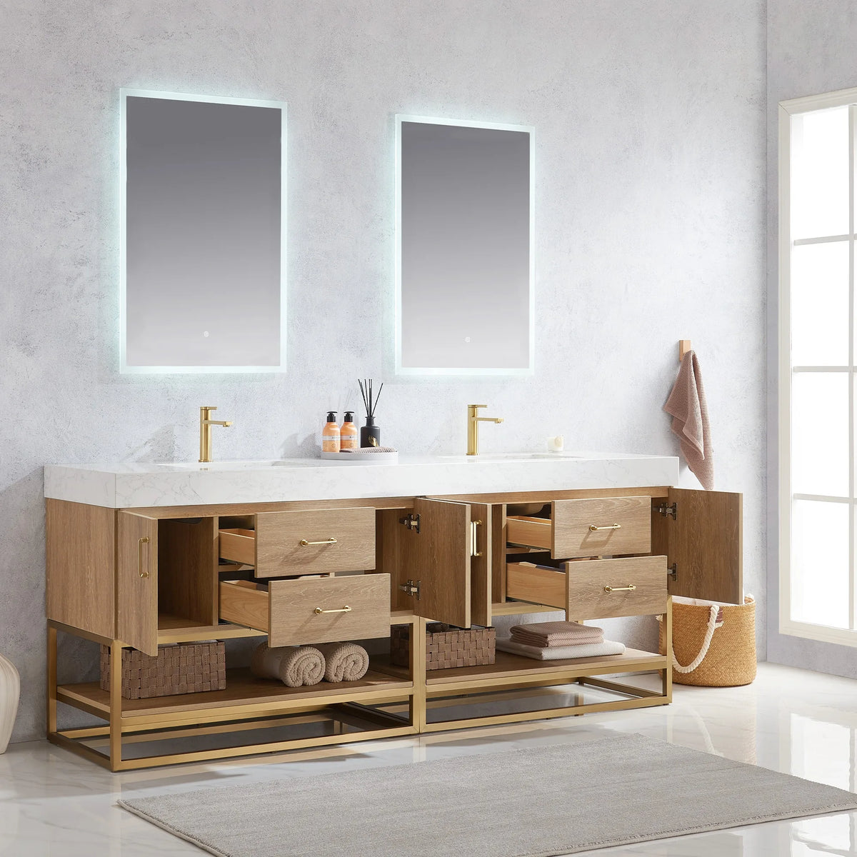 Room view of the double vanity with doors open and drawers extended, towels stored below, two lit mirrors above