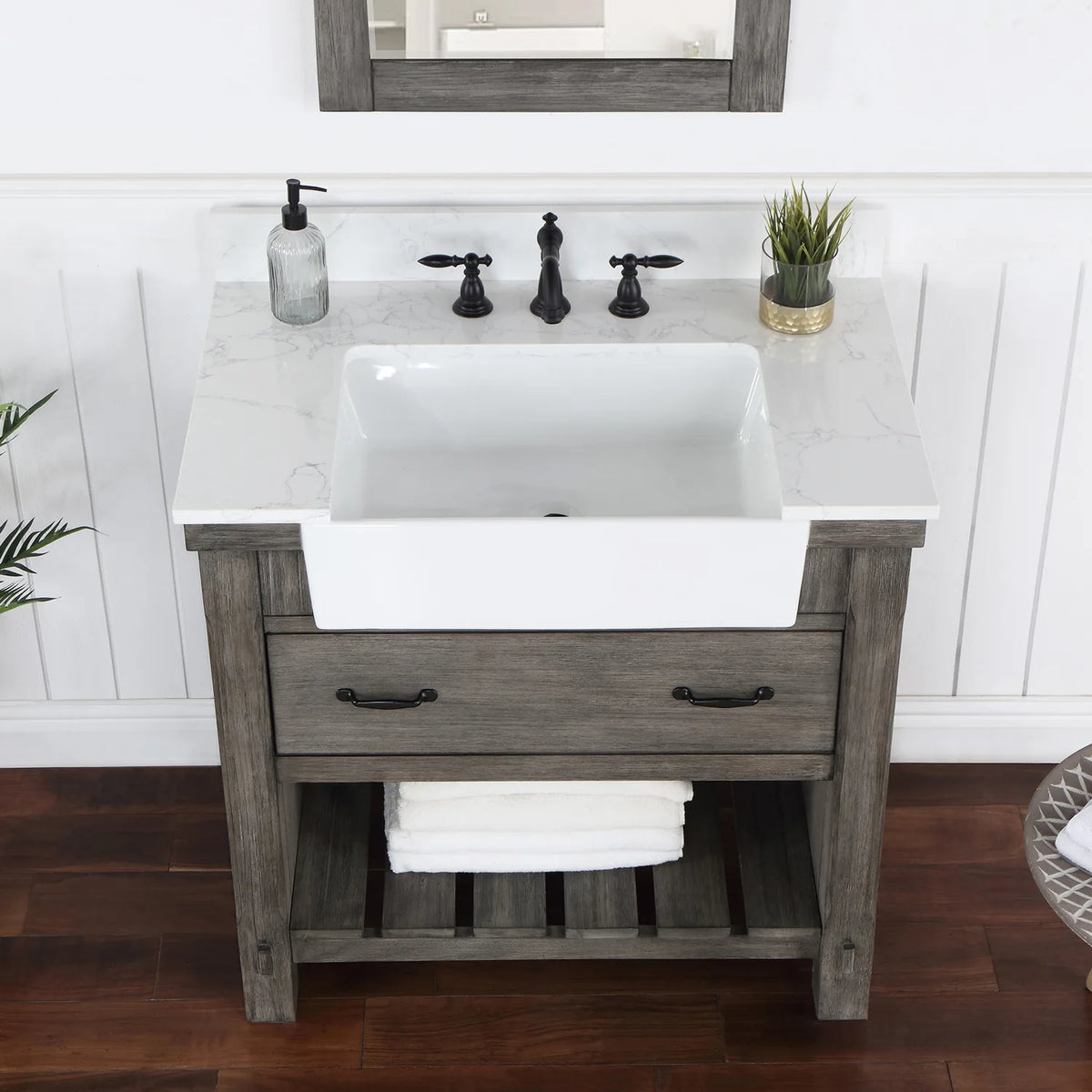 Stone top and white basin in a tighter crop, matte black pulls on the drawer front below