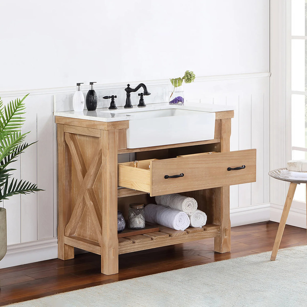 Single drawer open at an angle, X-brace side and open shelving with towels in view