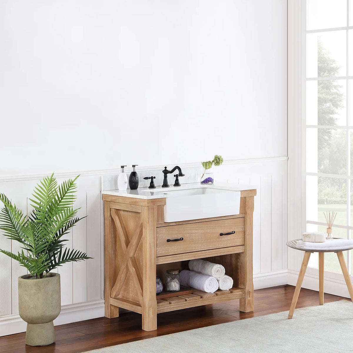 Vanity seen from a distance at an angle, window light and plant beside it