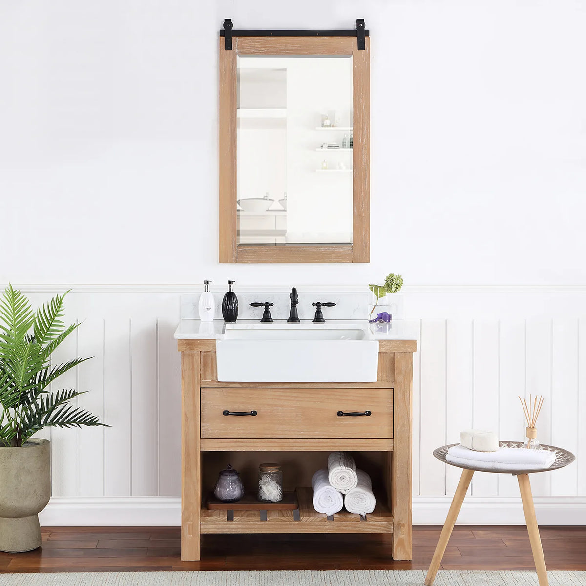 Rectangular mirror with sliding-rail hardware hung over the vanity in a styled room