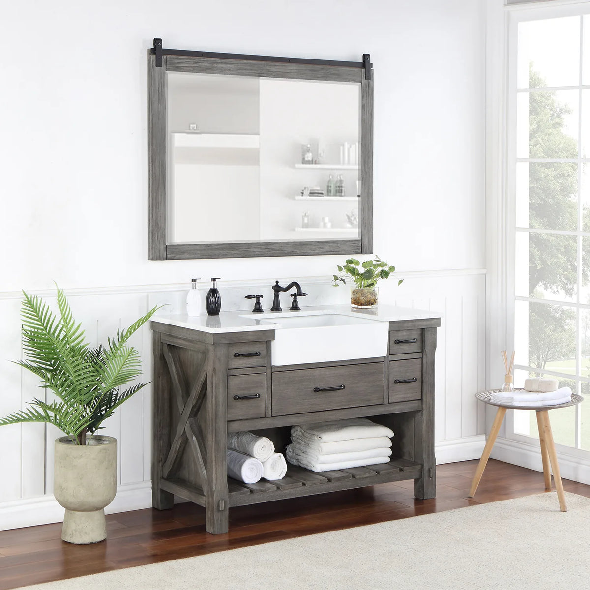 Styled bathroom with vanity, mirror, plant and towels on the slatted open shelving