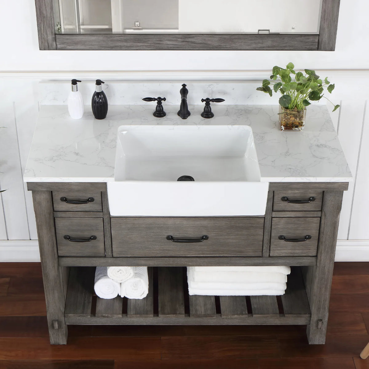 Stone top and white basin in a tighter crop, matte black pulls on the drawer fronts below