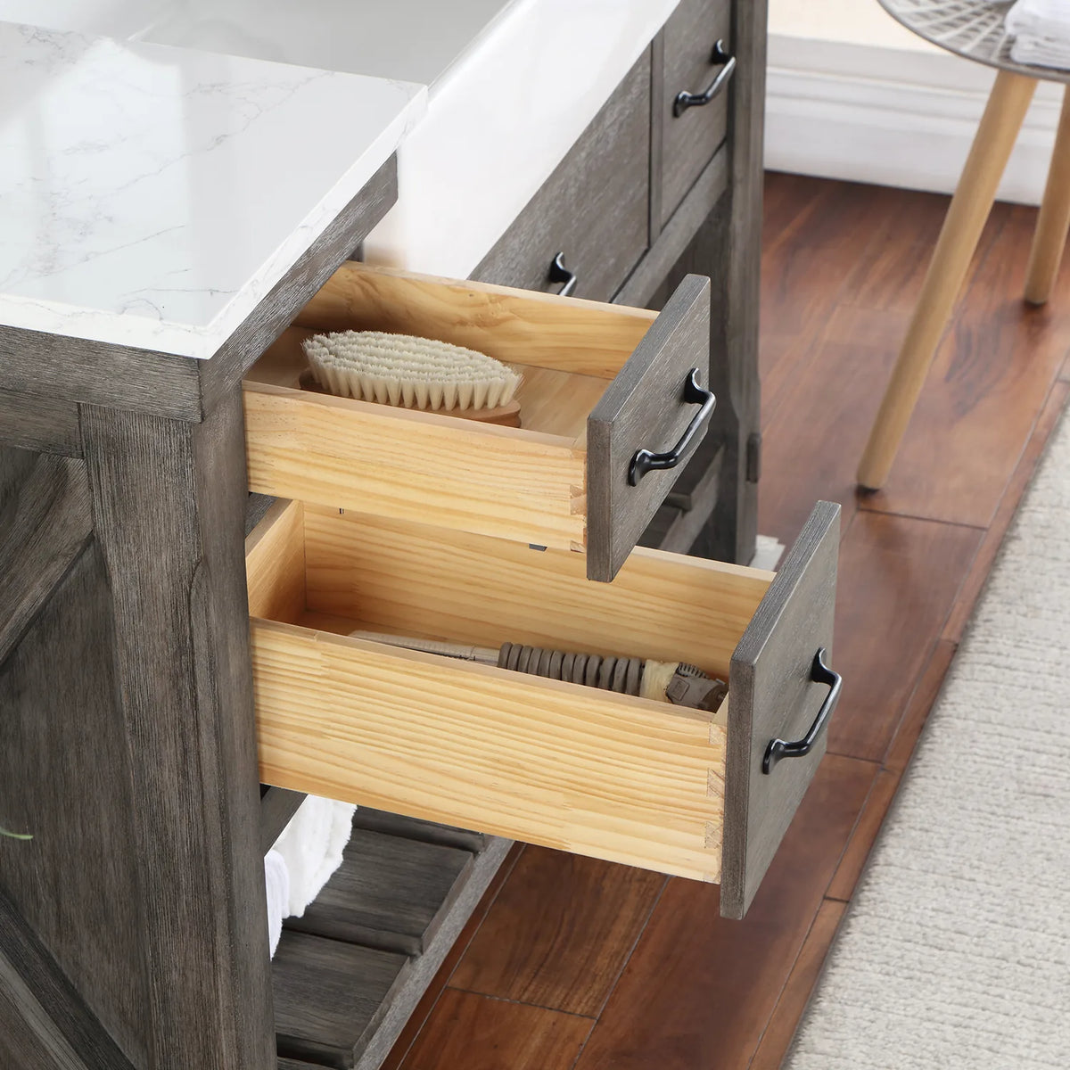 Small drawers pulled open, wood interiors holding brushes and bathroom items
