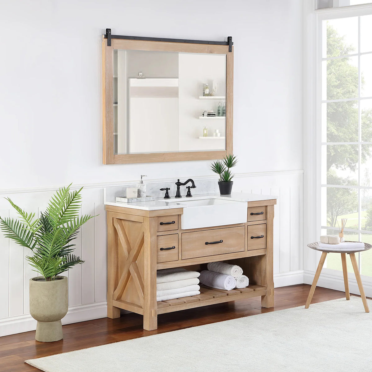 Styled bathroom with vanity, mirror, plant and towels on the slatted open shelving