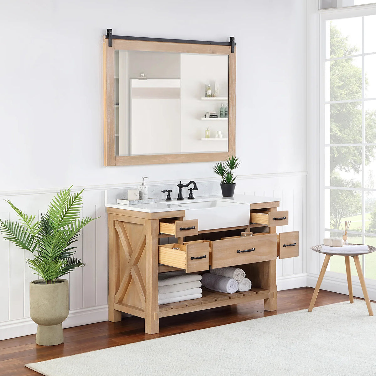 Mirror above the Weathered Pine vanity while the center and side drawers stand open