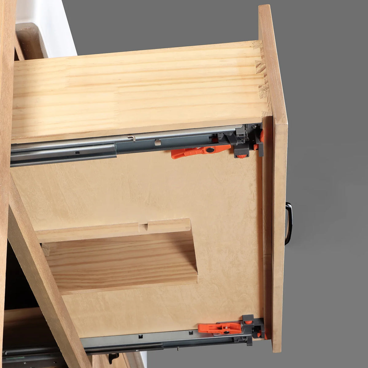 Full-extension drawer glide in close view with dovetailed wood box