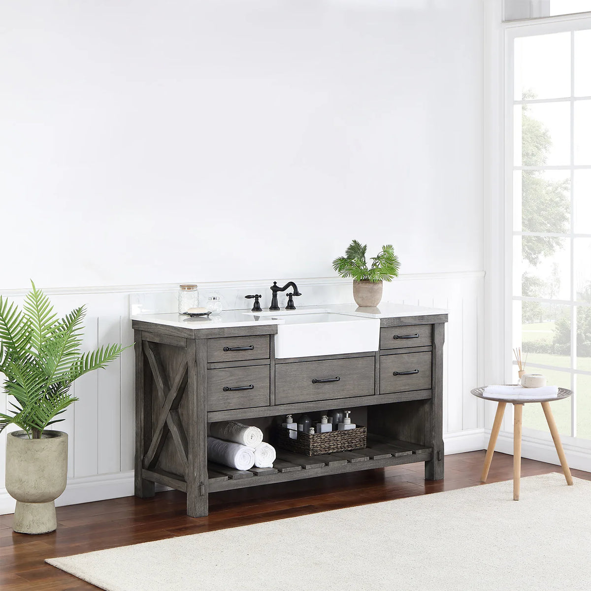 Vanity seen from a distance at an angle, window light and plant beside it