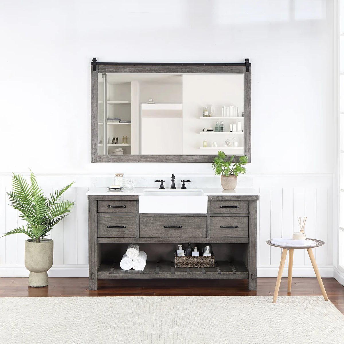 Rectangular mirror with sliding-rail hardware hung over the vanity in a styled room