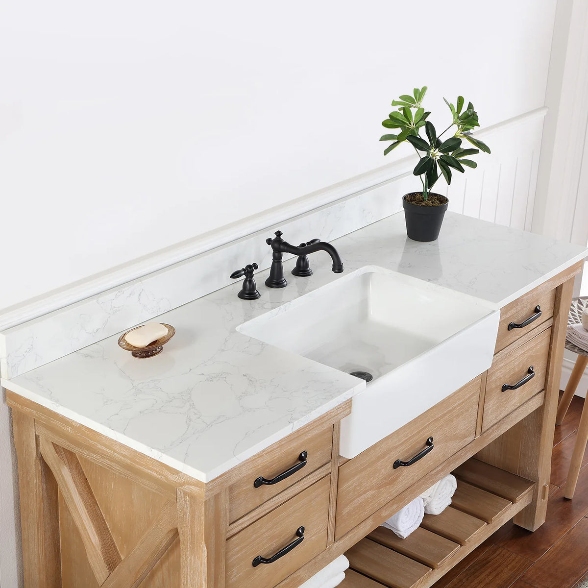 Angle across the white basin and backsplash with a black widespread faucet (sold separately)