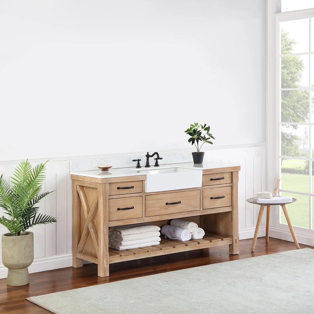 Vanity seen from a distance at an angle, window light and plant beside it