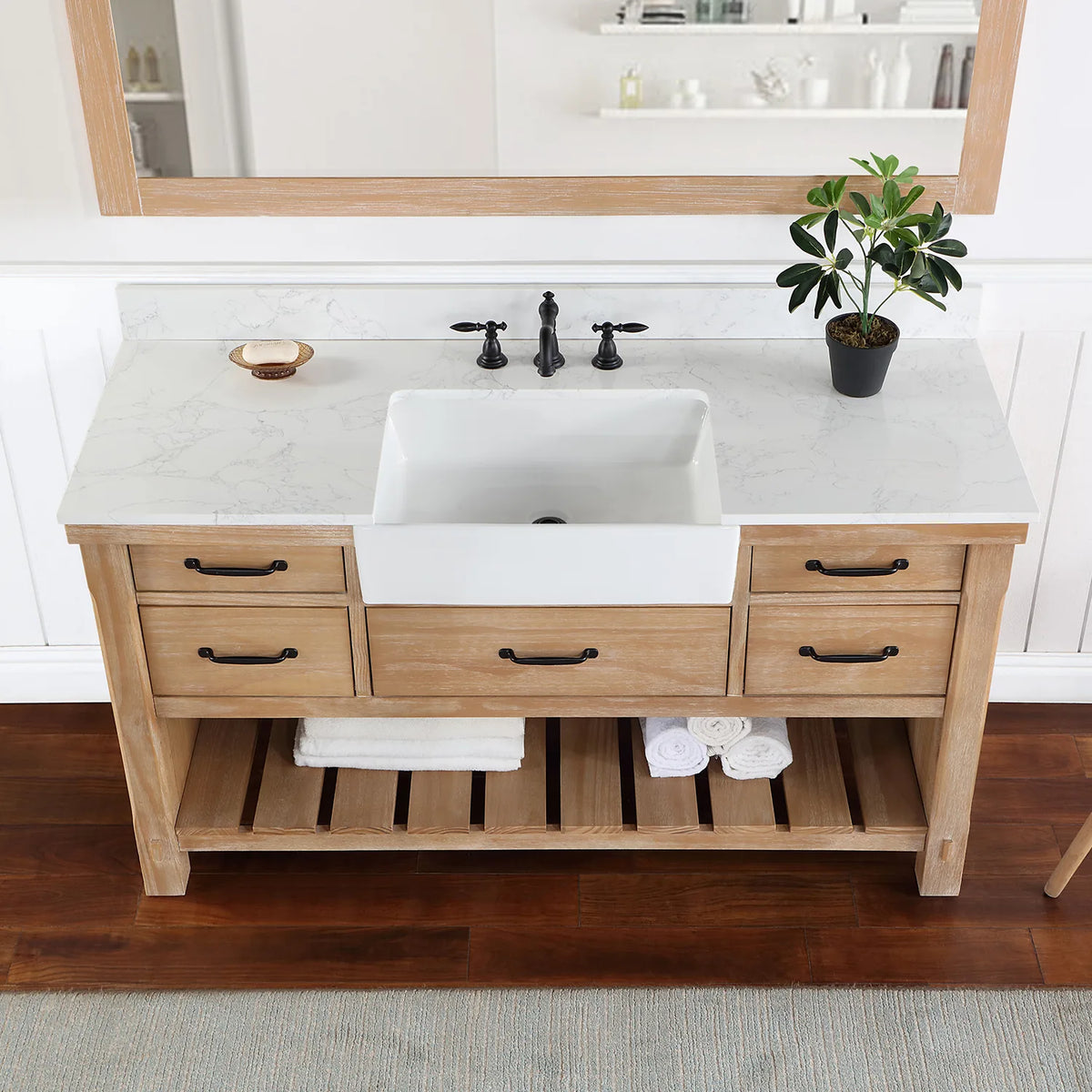 Stone top and white basin in a tighter crop, matte black pulls on the drawer fronts below