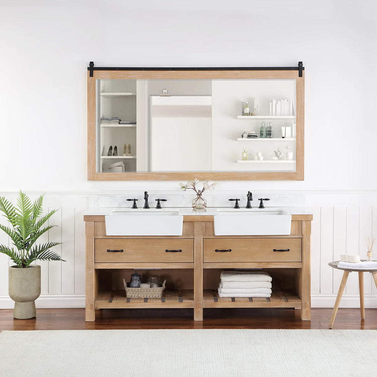 Rectangular mirror with sliding-rail hardware hung over the vanity in a styled room