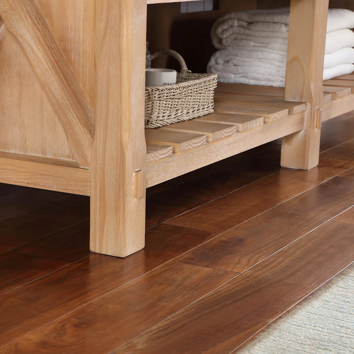 Lower corner showing the leg, crossed brace and slatted open shelving