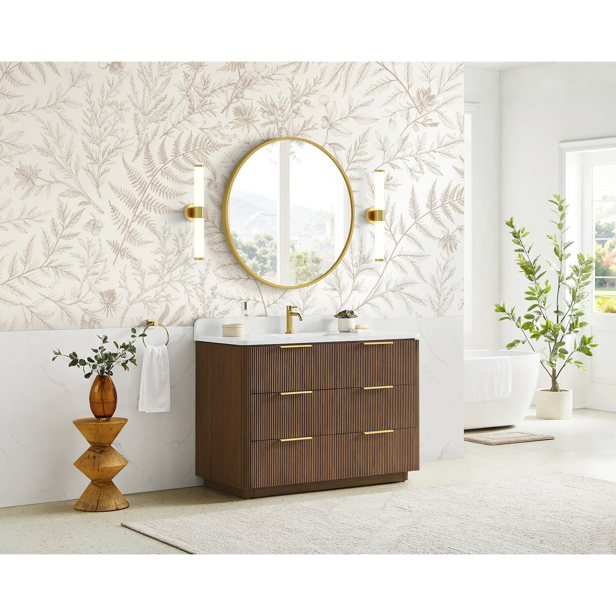 Wide room scene with a 48 inch single sink vanity, leaf wallpaper and a freestanding tub