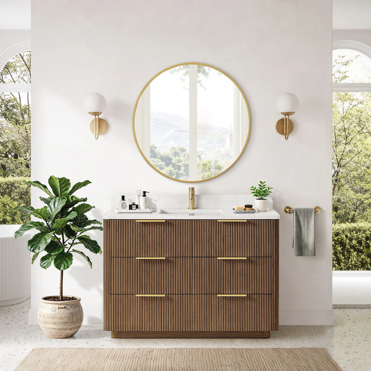 Room view, front: single sink vanity staged beside a white wall and a large plant