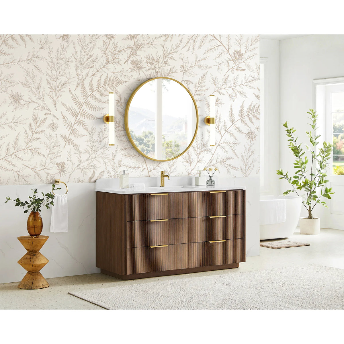 Full bathroom shot: single sink vanity in Oak Light Walnut, leaf wallpaper and a freestanding tub