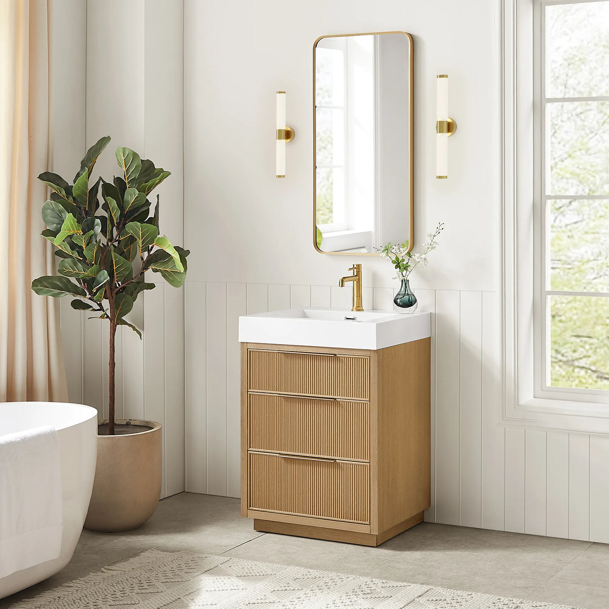 Bathroom scene with a potted plant, pairing the 24-inch Washed Ash Grey vanity with its matching mirror and wall sconces