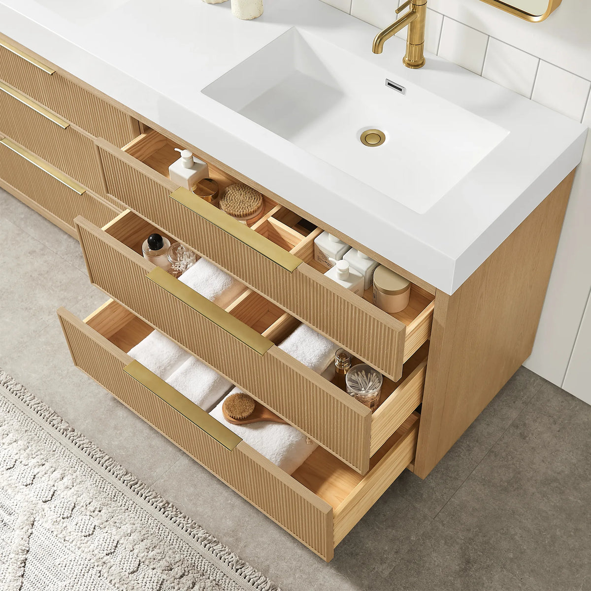 Angled look into the open drawers of the 60-inch double vanity, with wooden partitions and the white basin top above