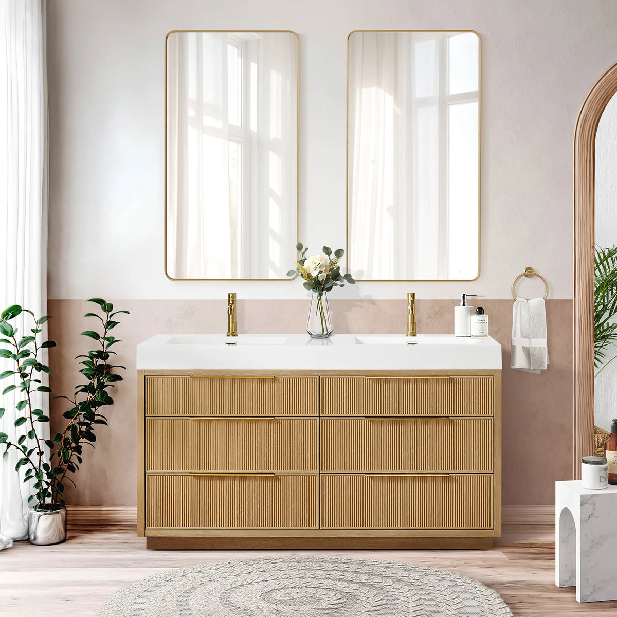 Lifestyle shot of the 60-inch double vanity, twin rectangular mirrors and a vase of flowers, plus a pink wall with an arch
