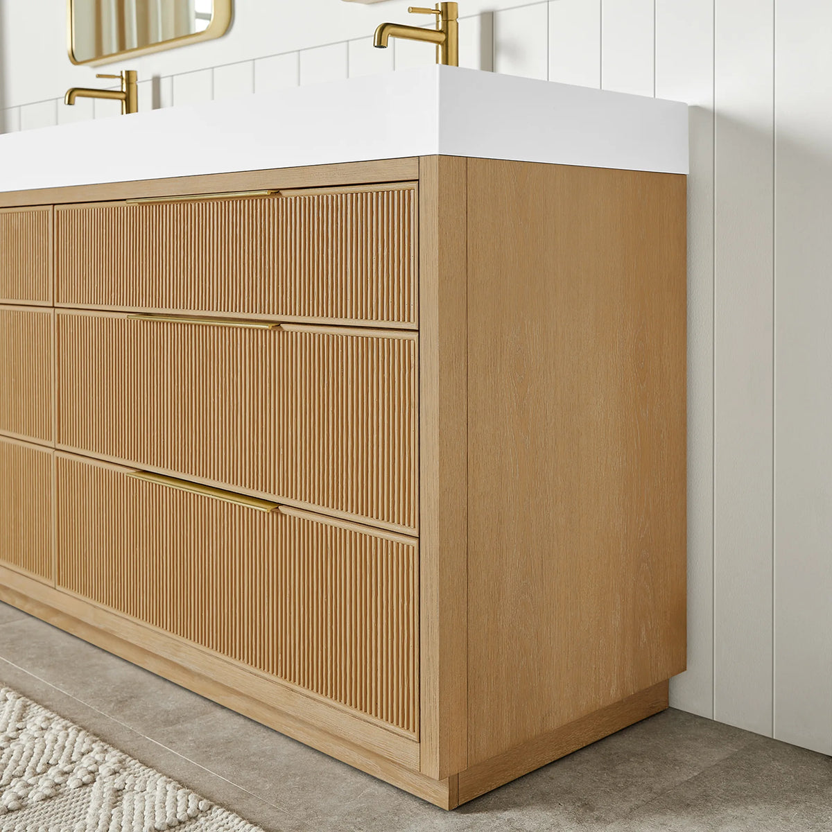 Corner view of the 60-inch Washed Ash Grey cabinet, fluted fronts with slim pulls, standing on a recessed base