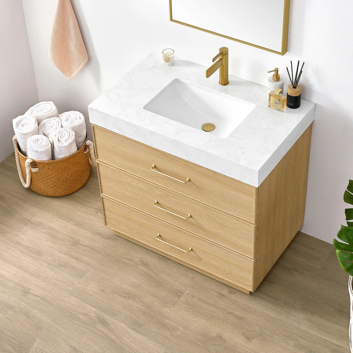 Angled close-up of the Dark Oak vanity with its undermount sink, brushed gold handles and rolled towels