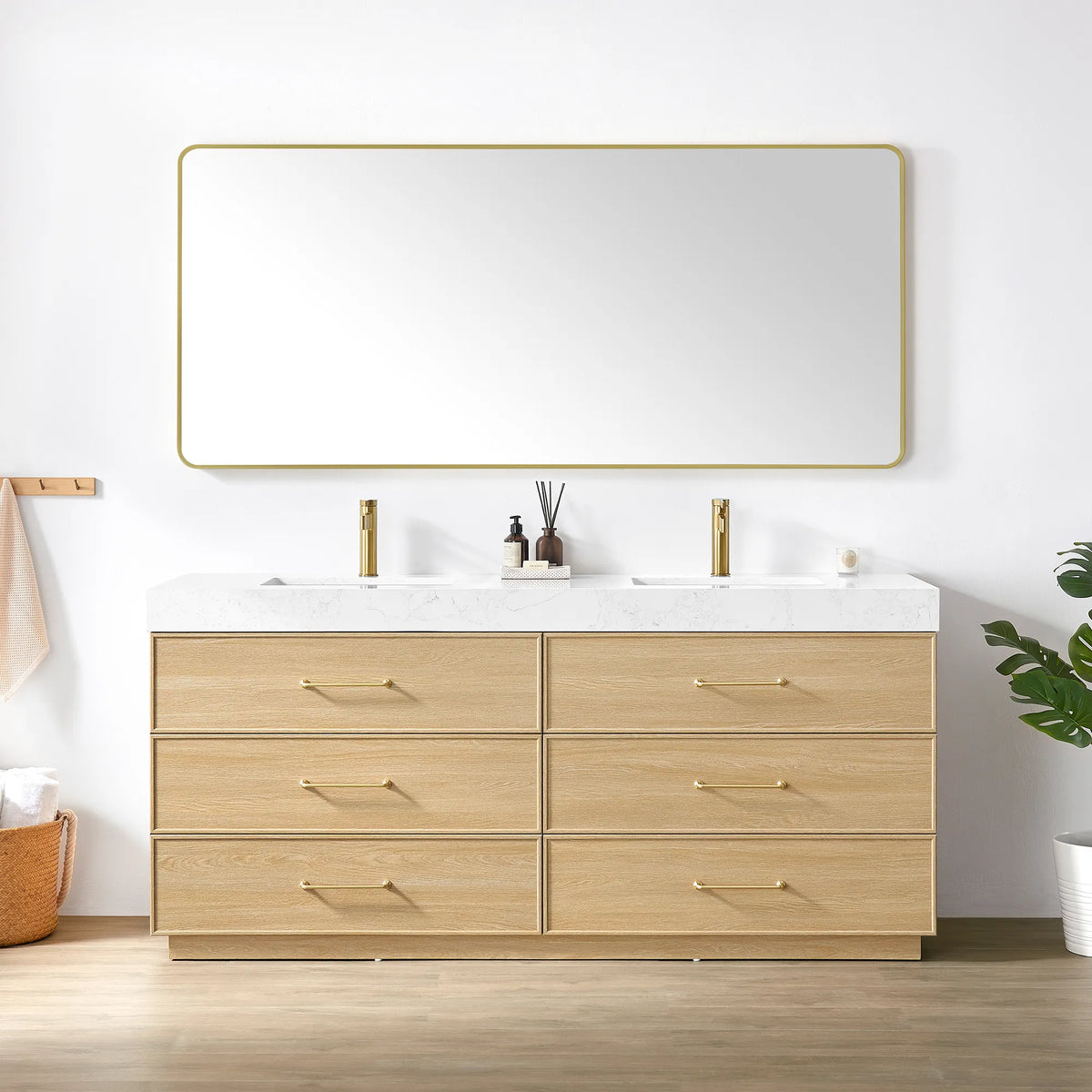 Dark Oak vanity and matching rounded-rectangle mirror with a slim gold frame, styled with towels and a plant