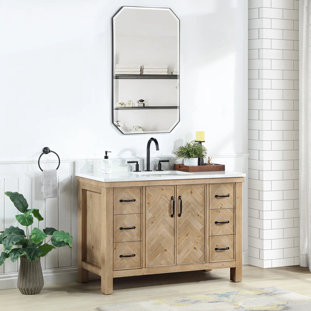 Wall mirror above the 48 inch single vanity, with a plant and tray on the counter