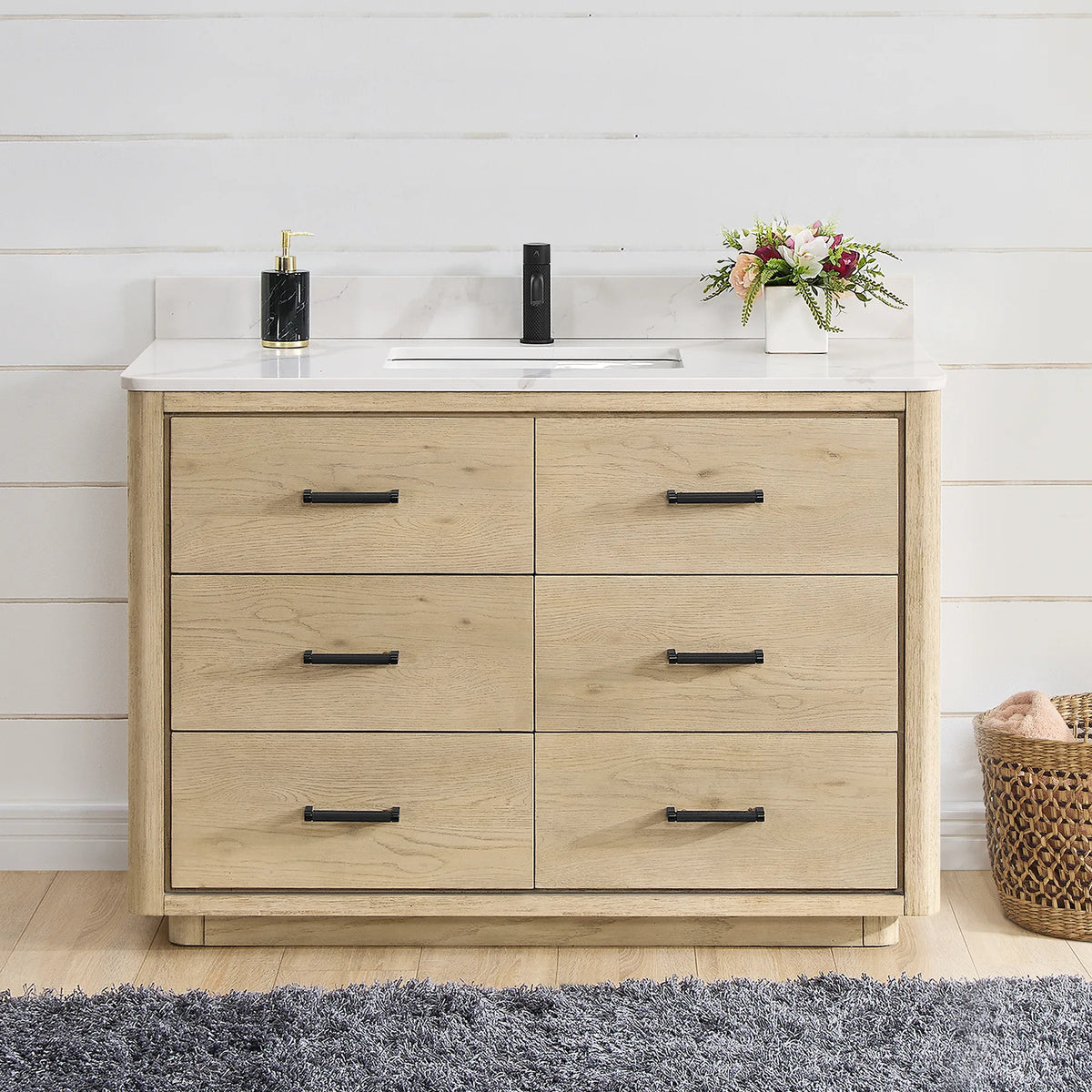 Front view of a 48 inch single vanity in Aged Natural Oak, styled in a shiplap bathroom with matte black hardware