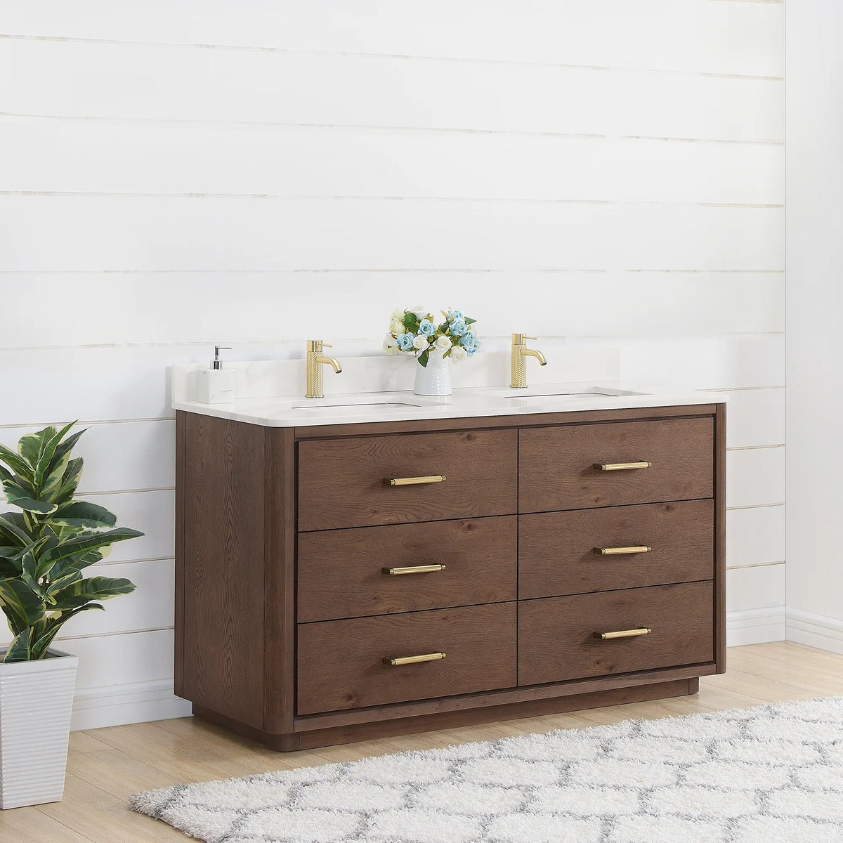 Bathroom scene, double vanity set at an angle against white shiplap, a tall plant beside it