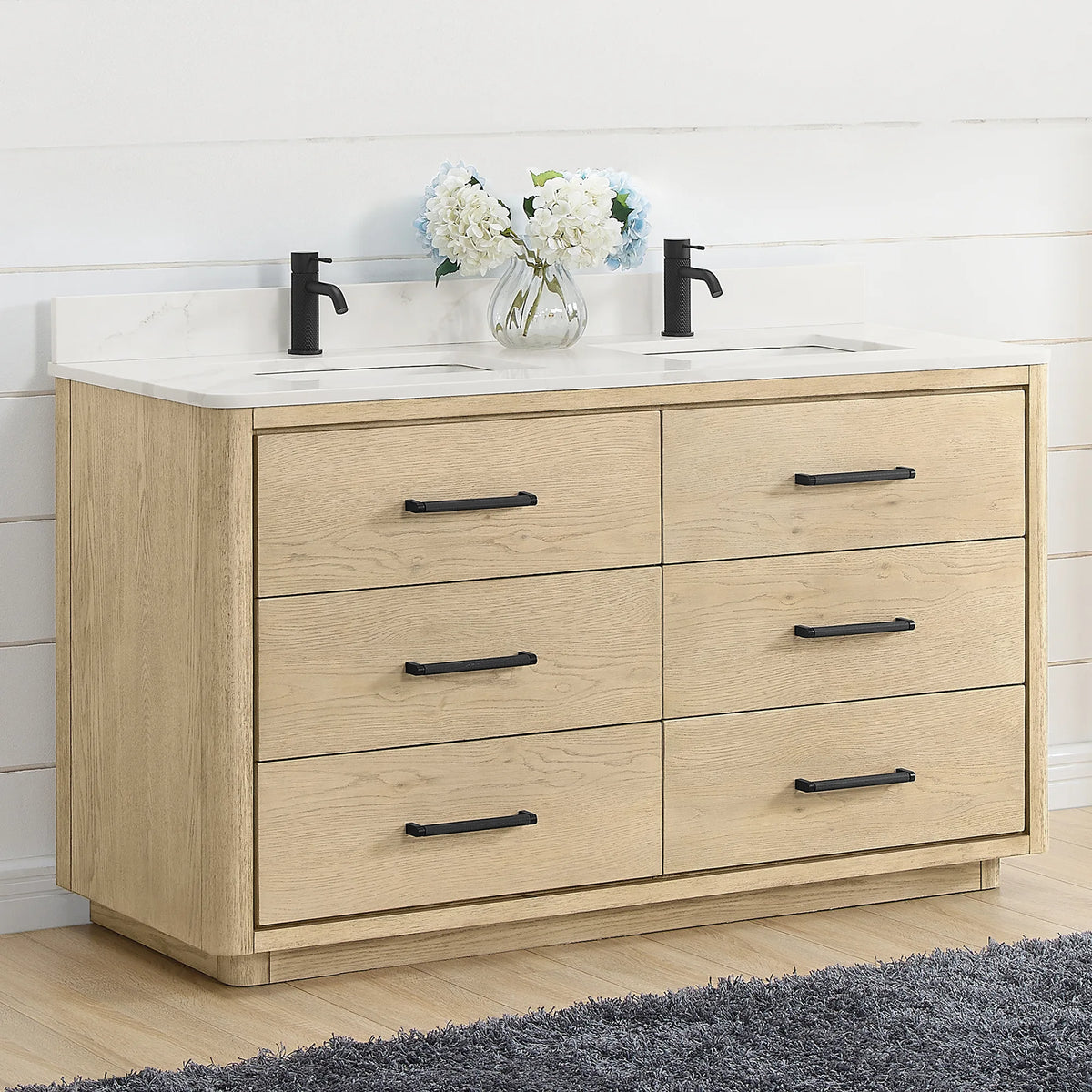 Angled room view of a 60 inch double vanity in Aged Natural Oak with matte black pulls