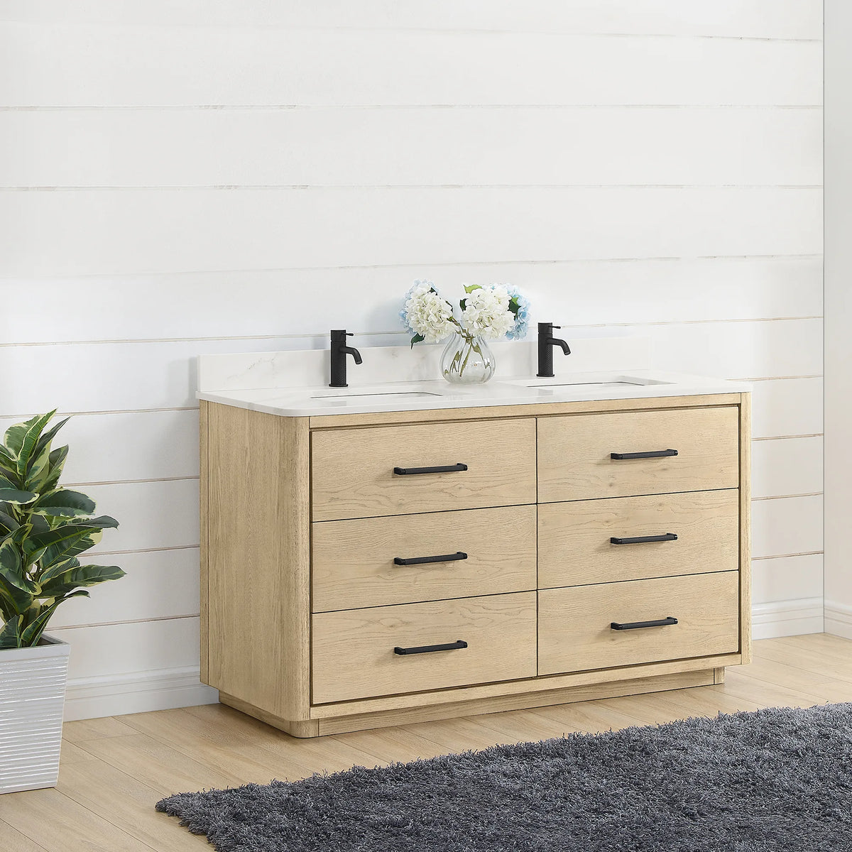 Bathroom scene, double vanity set at an angle against white shiplap, a tall plant beside it, 60 inch width