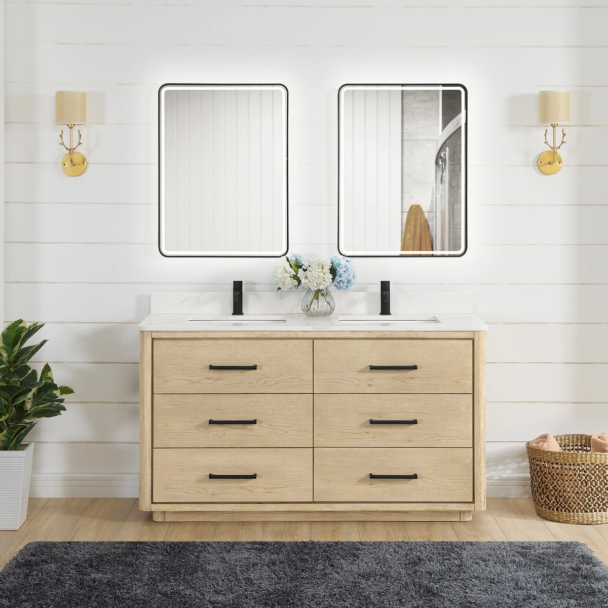 60 inch double vanity in Aged Natural Oak with two LED mirrors, shown in a bathroom with gold wall sconces