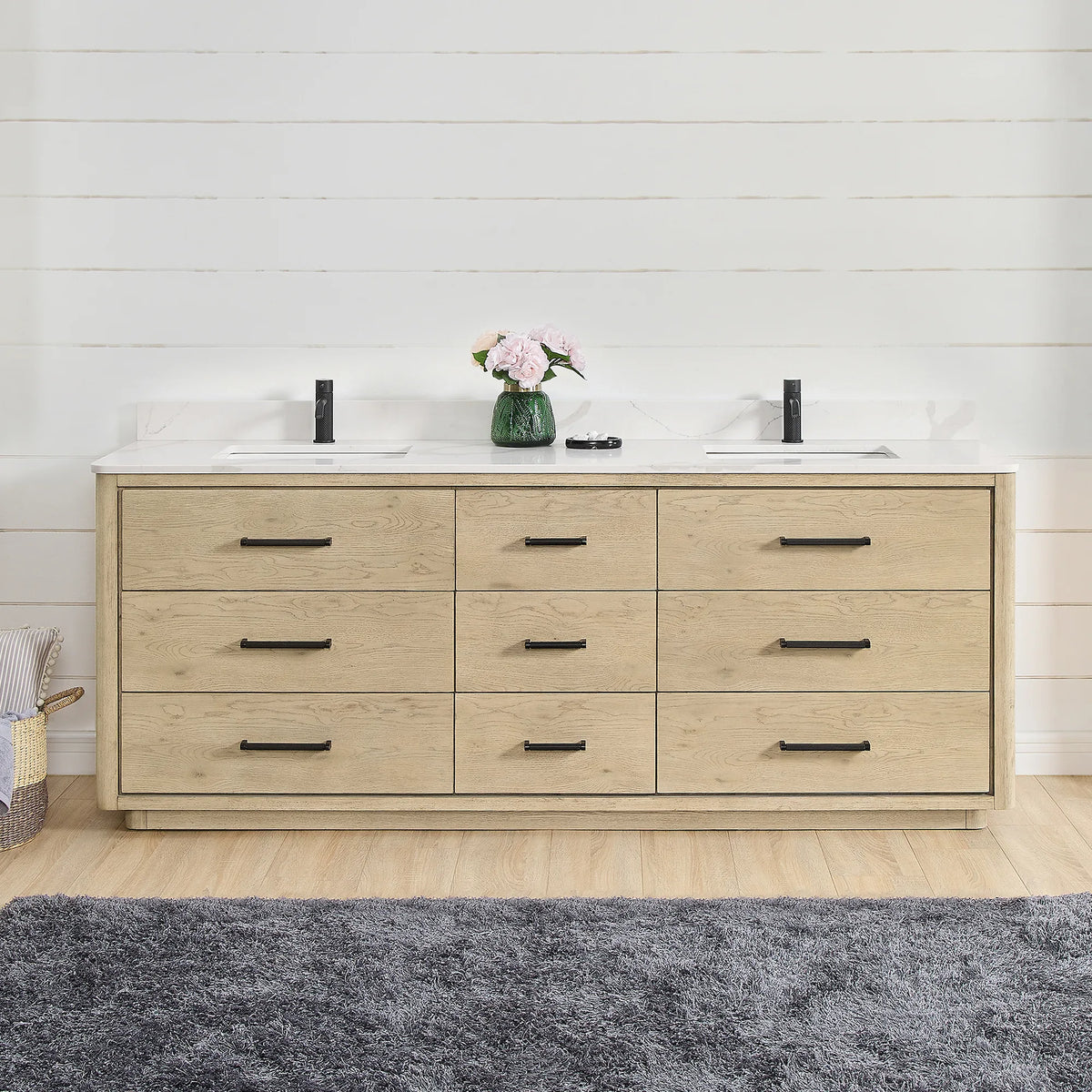 Front view of an 84 inch double vanity in Aged Natural Oak, styled in a shiplap bathroom with matte black hardware