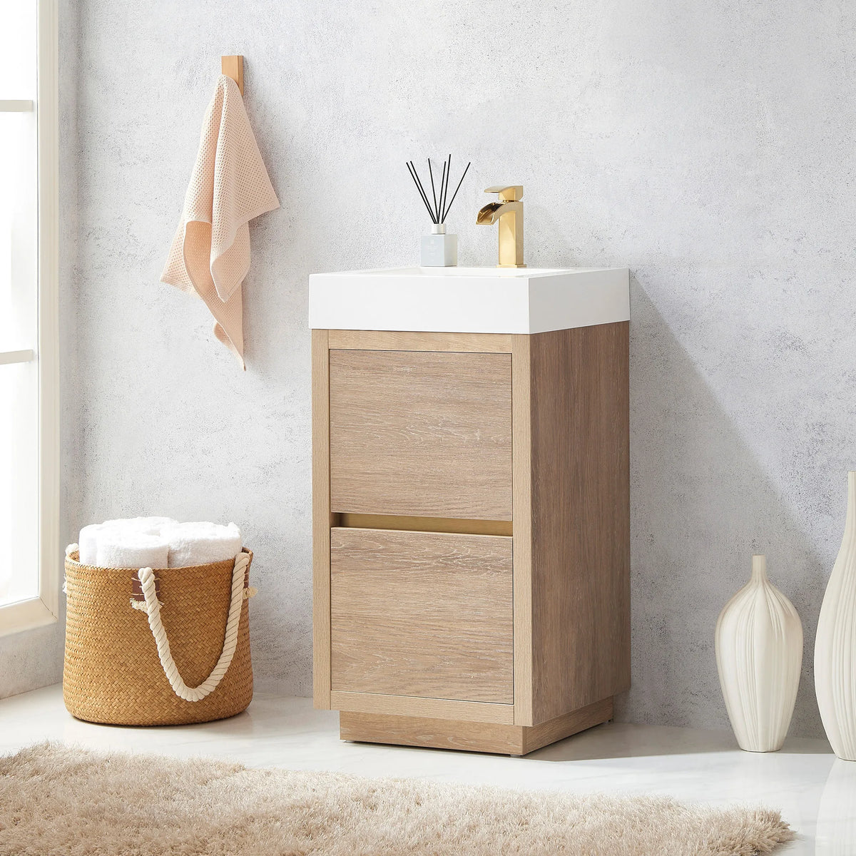 Angled view of the vanity on a white floor with a rug, towel basket and white vases