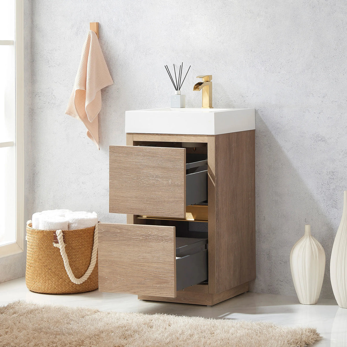 Vanity with drawers open, gray drawer interiors visible, towel basket beside it