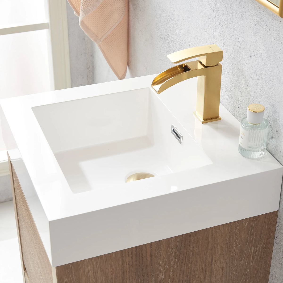 Detail of the white integrated sink with a perfume bottle on the 18 inch vanity top