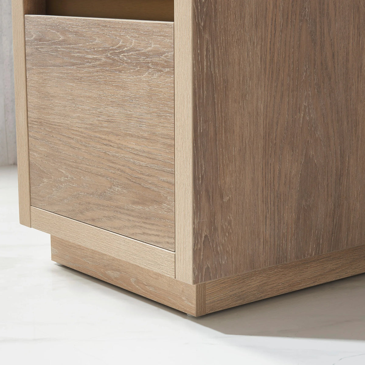Close-up of the oak panel and plinth base, floor shadow beneath