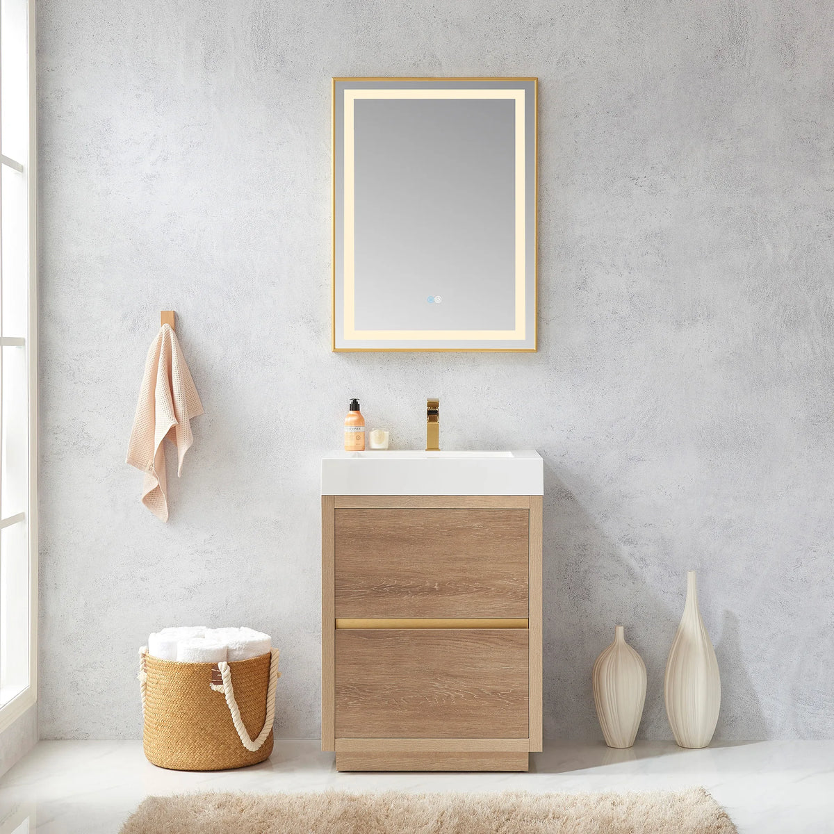 Room scene with the 24 inch vanity, lit mirror above, towel hook, amber bottle and tall white vases