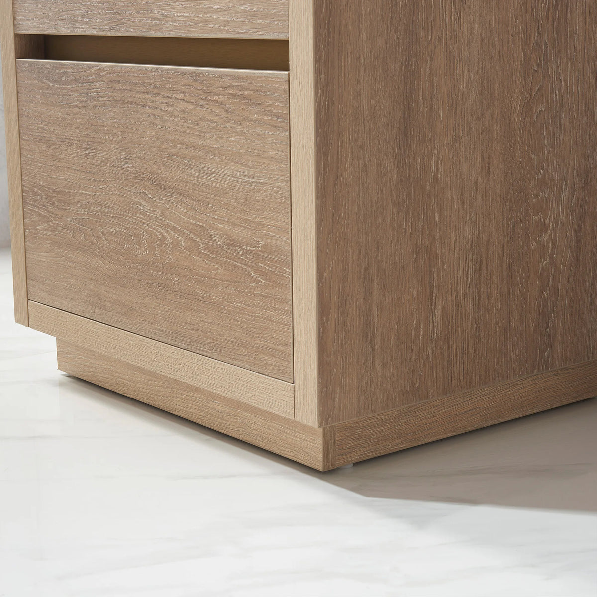 Close-up of the 24 inch vanity side panel and plinth on a white floor