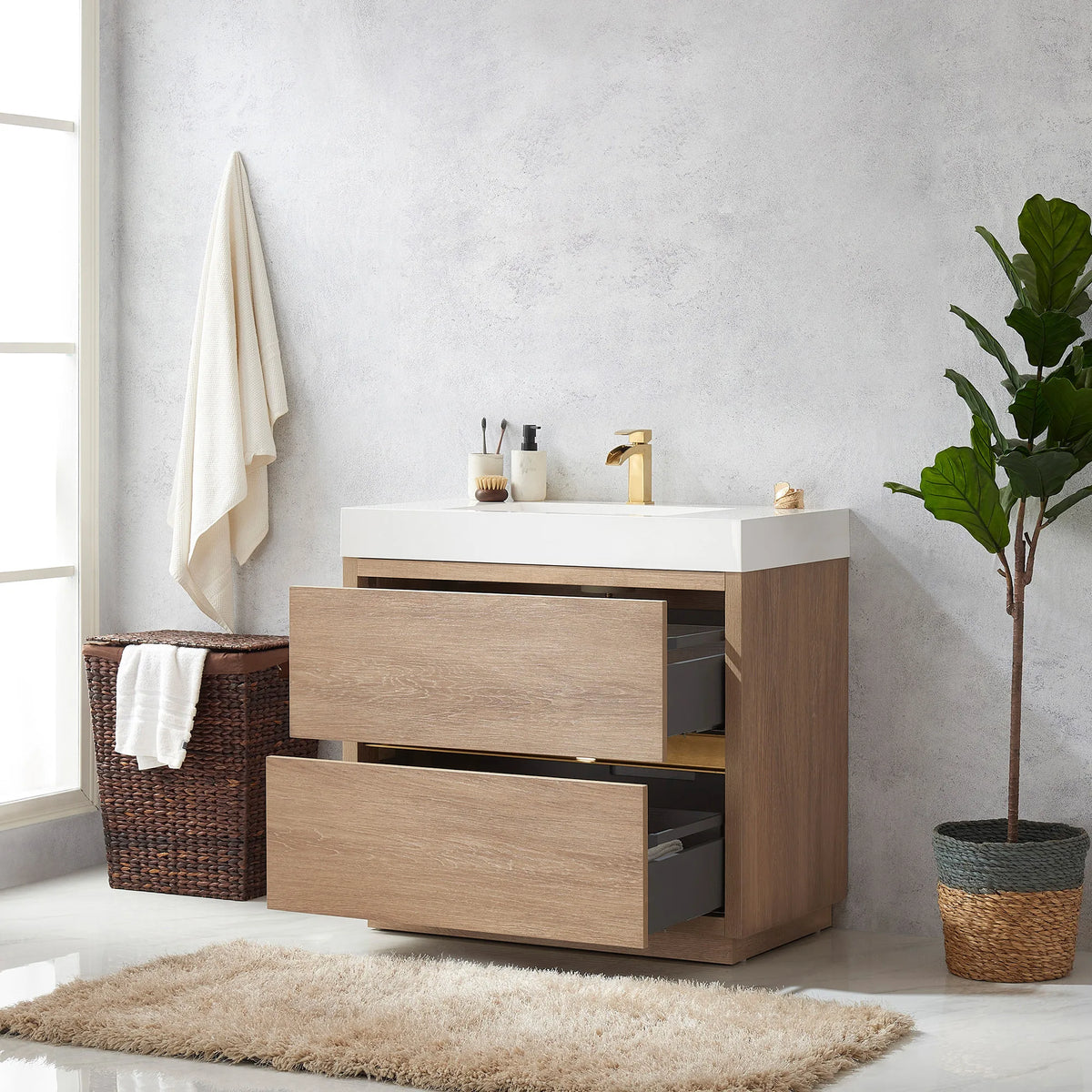 Vanity with the drawers pulled open, gray interiors visible, hamper and plant at the sides