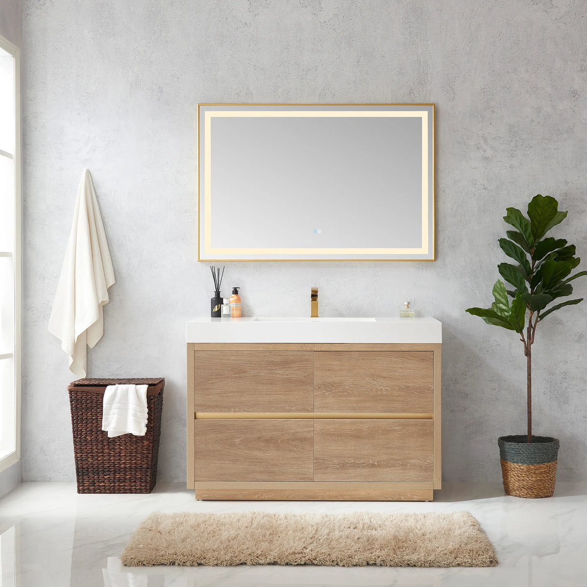Room scene of the 48 inch vanity with horizontal LED mirror, hanging towel, hamper and potted plant