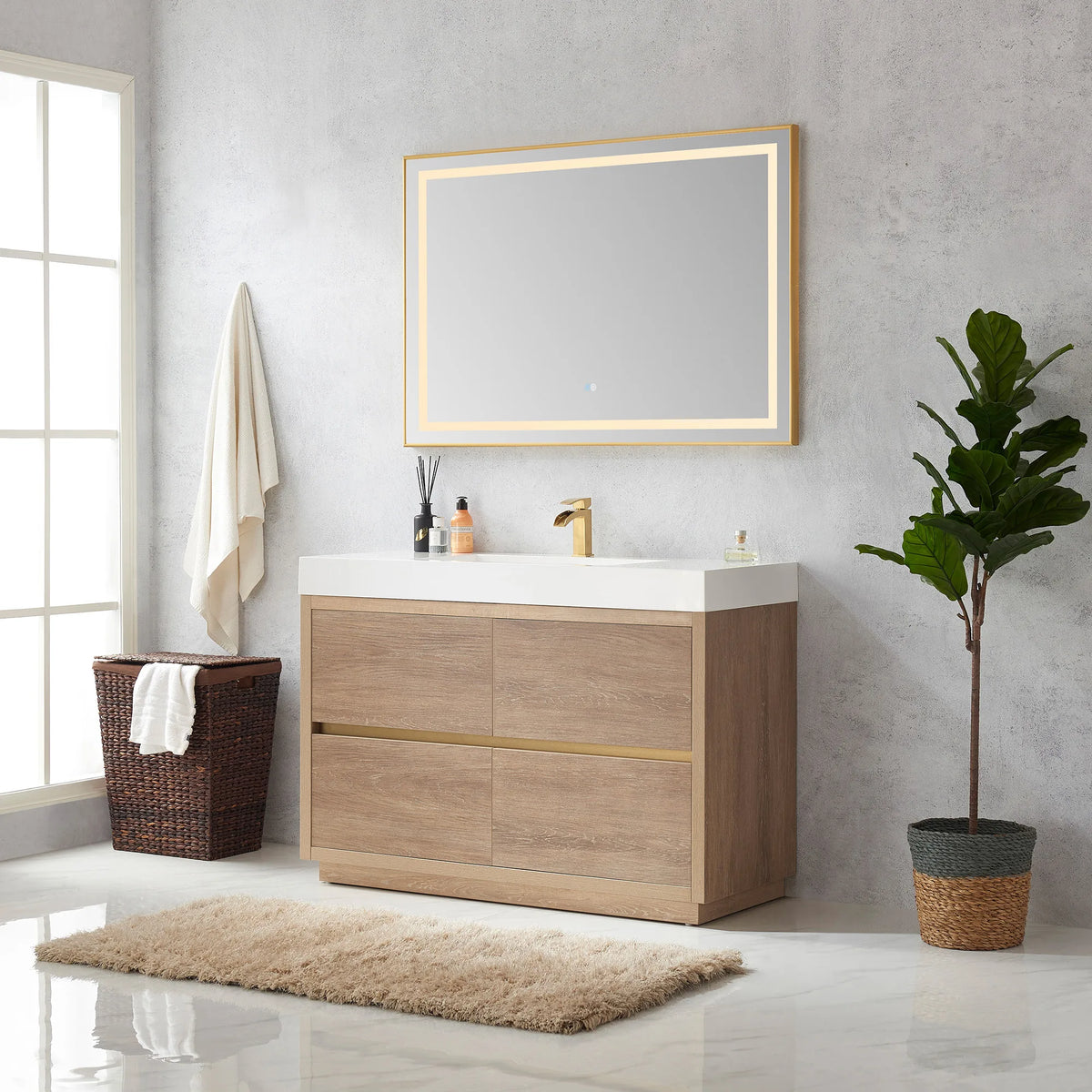 Room view of the 48 inch vanity with mirror beside a window, hamper and plant, rug on floor